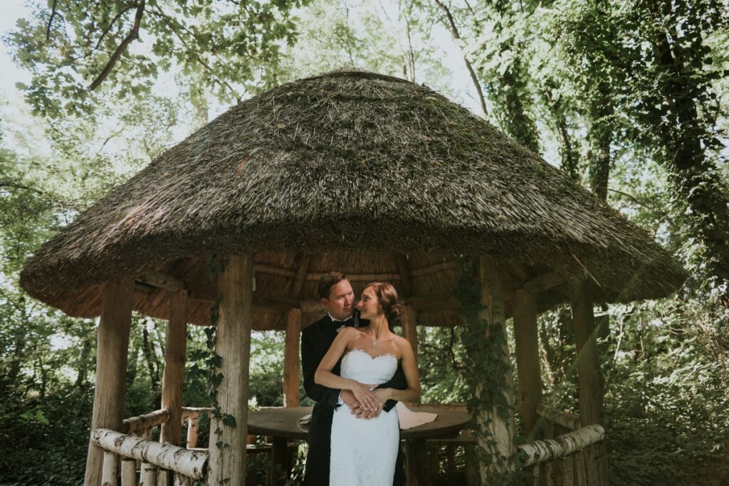 Kreatív esküvői fotó nád­tetős épületben, Geréby Kúria esküvői helyszínen